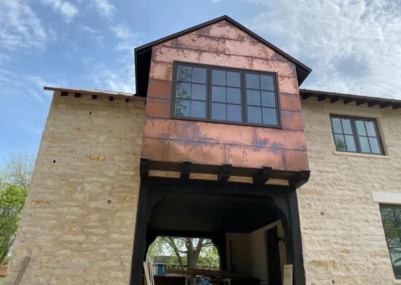 Copper metal panel facade on a stone building for Skylight Installation in Whitemarsh Island